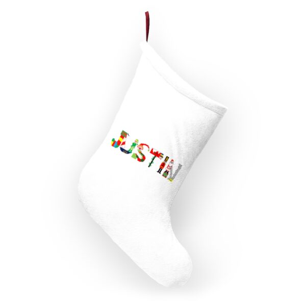 White stocking with text ‘Justin’ in colourful Christmas themed lettering, with red hanging loop