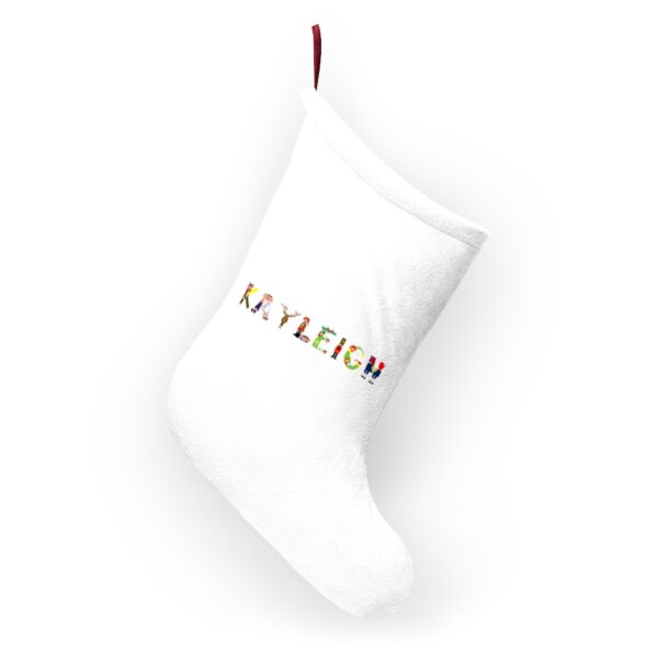 White stocking with text ‘Kayleigh’ in colourful Christmas themed lettering, with red hanging loop