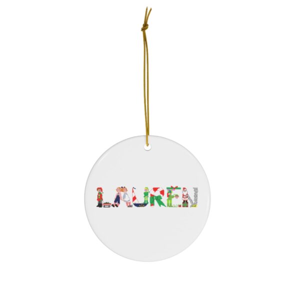 White ceramic ornament with text ‘Lauren’ in colourful Christmas themed lettering, with gold hanging loop