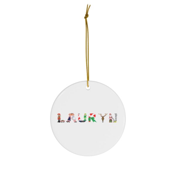 White ceramic ornament with text ‘Lauryn’ in colourful Christmas themed lettering, with gold hanging loop