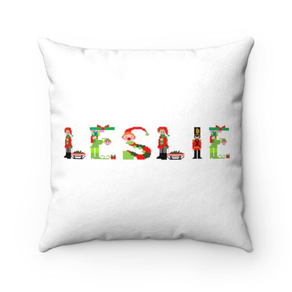 White faux suede cushion with text ‘Leslie’ in colourful Christmas themed lettering