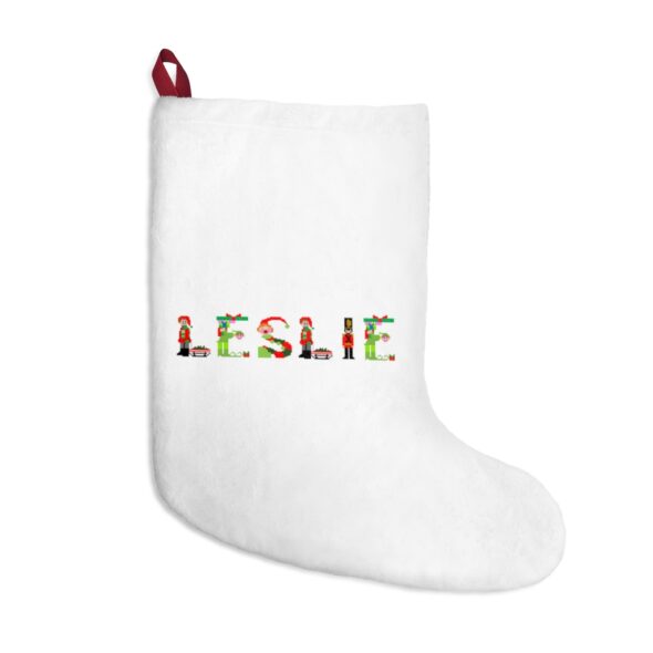 White stocking with text ‘Leslie’ in colourful Christmas themed lettering, with red hanging loop