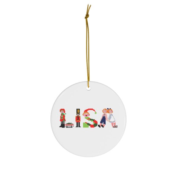 White ceramic ornament with text ‘Lisa’ in colourful Christmas themed lettering, with gold hanging loop