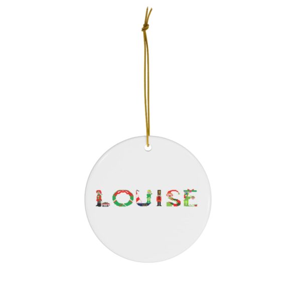 White ceramic ornament with text ‘Louise’ in colourful Christmas themed lettering, with gold hanging loop