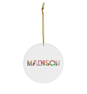 White ceramic ornament with text ‘Madison’ in colourful Christmas themed lettering, with gold hanging loop