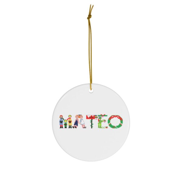 White ceramic ornament with text ‘Mateo’ in colourful Christmas themed lettering, with gold hanging loop