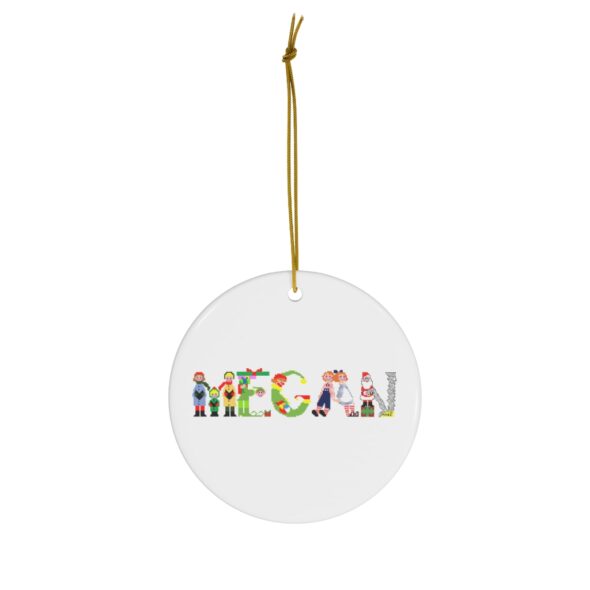 White ceramic ornament with text ‘Megan’ in colourful Christmas themed lettering, with gold hanging loop