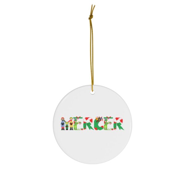 White ceramic ornament with text ‘Mercer’ in colourful Christmas themed lettering, with gold hanging loop