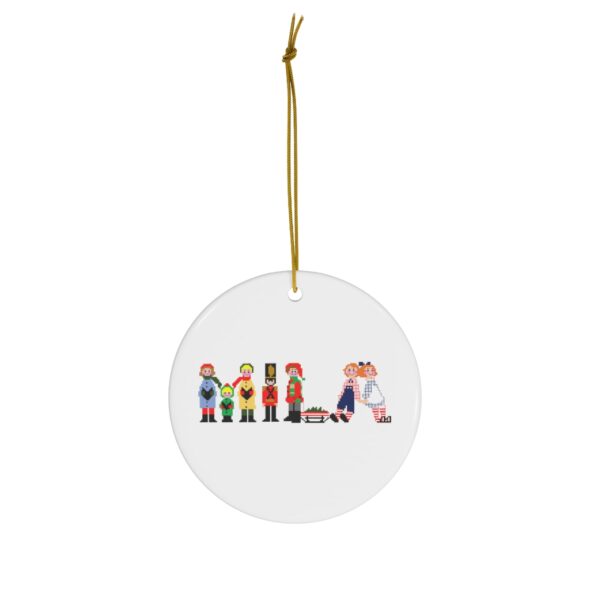 White ceramic ornament with text ‘Mila’ in colourful Christmas themed lettering, with gold hanging loop