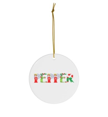 White ceramic ornament with text ‘Pepper’ in colourful Christmas themed lettering, with gold hanging loop