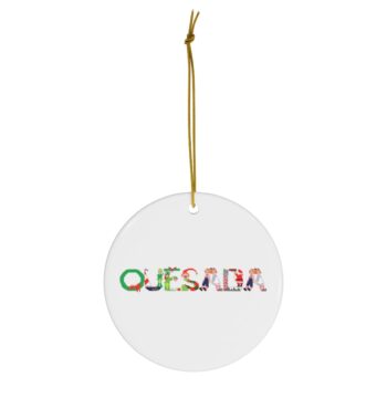 White ceramic ornament with text ‘Quesada’ in colourful Christmas themed lettering, with gold hanging loop