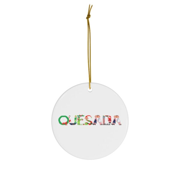 White ceramic ornament with text ‘Quesada’ in colourful Christmas themed lettering, with gold hanging loop