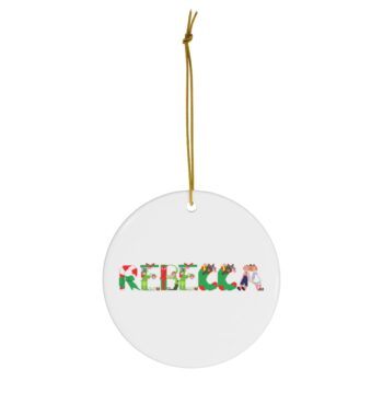 White ceramic ornament with text ‘Rebecca’ in colourful Christmas themed lettering, with gold hanging loop