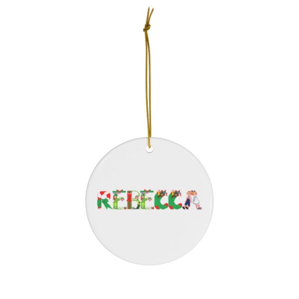 White ceramic ornament with text ‘Rebecca’ in colourful Christmas themed lettering, with gold hanging loop