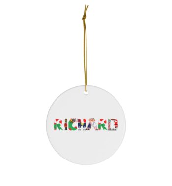 White ceramic ornament with text ‘Richard’ in colourful Christmas themed lettering, with gold hanging loop