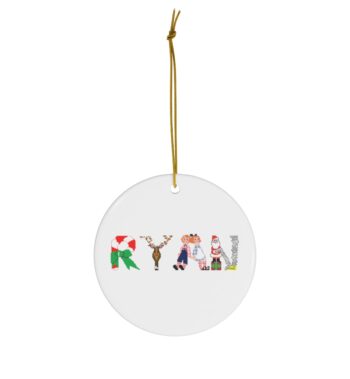White ceramic ornament with text ‘Ryan’ in colourful Christmas themed lettering, with gold hanging loop