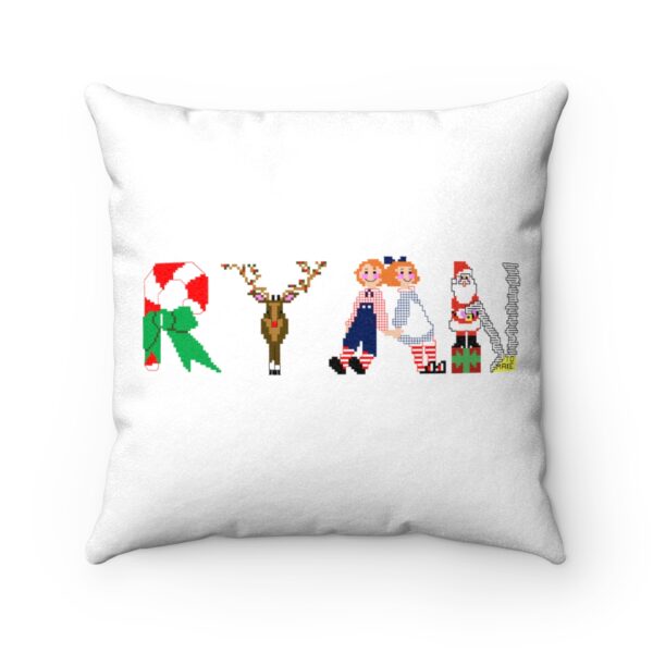 White faux suede cushion with text ‘Ryan’ in colourful Christmas themed lettering