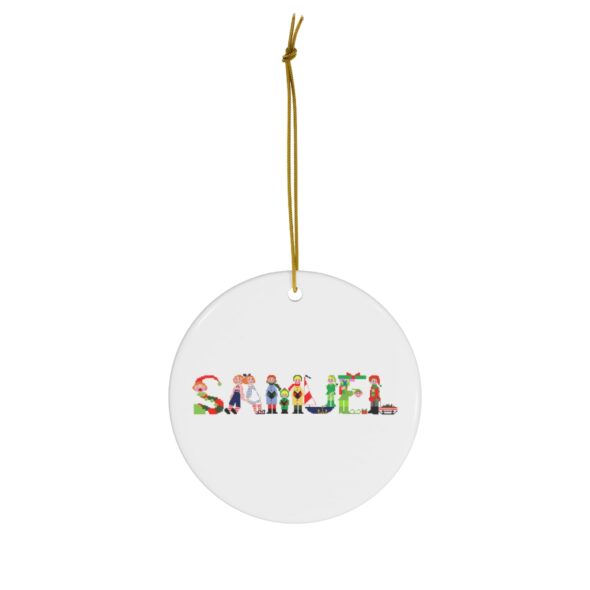 White ceramic ornament with text ‘Samuel’ in colourful Christmas themed lettering, with gold hanging loop