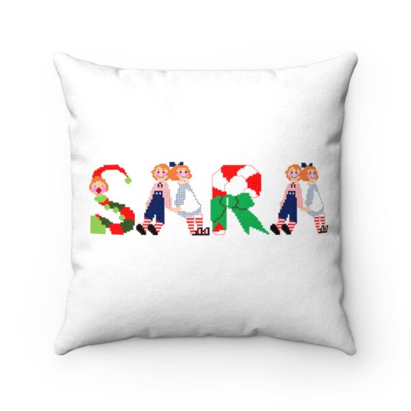 White faux suede cushion with text ‘Sara’ in colourful Christmas themed lettering