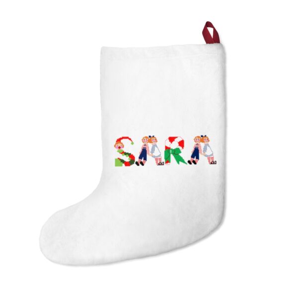 White stocking with text ‘Sara’ in colourful Christmas themed lettering, with red hanging loop