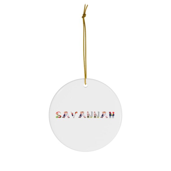 White ceramic ornament with text ‘Savannah’ in colourful Christmas themed lettering, with gold hanging loop