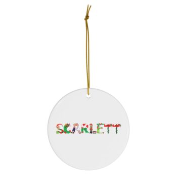 White ceramic ornament with text ‘Scarlett’ in colourful Christmas themed lettering, with gold hanging loop