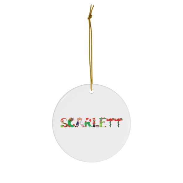 White ceramic ornament with text ‘Scarlett’ in colourful Christmas themed lettering, with gold hanging loop