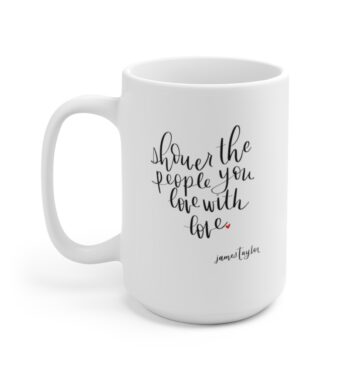 White 15 ounce mug, featuring the lyric ‘Shower the people you love with love’ in the shape of a heart