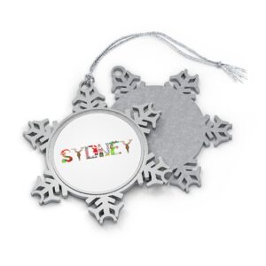 Silver-toned snowflake ornament with white insert with text ‘Sydney’ in colourful Christmas themed lettering, with silver hanging loop