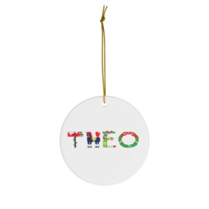 White ceramic ornament with text ‘Theo’ in colourful Christmas themed lettering, with gold hanging loop