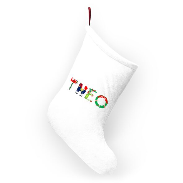 White stocking with text ‘Theo’ in colourful Christmas themed lettering, with red hanging loop