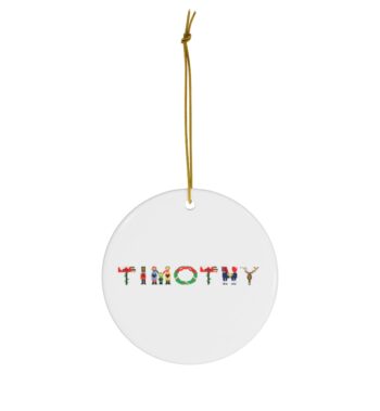 White ceramic ornament with text ‘Timothy’ in colourful Christmas themed lettering, with gold hanging loop