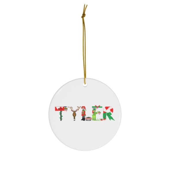 White ceramic ornament with text ‘Tyler’ in colourful Christmas themed lettering, with gold hanging loop