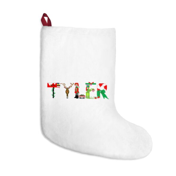 White stocking with text ‘Tyler’ in colourful Christmas themed lettering, with red hanging loop