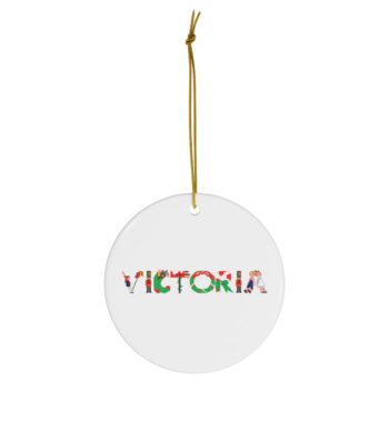 White ceramic ornament with text ‘Victoria’ in colourful Christmas themed lettering, with gold hanging loop