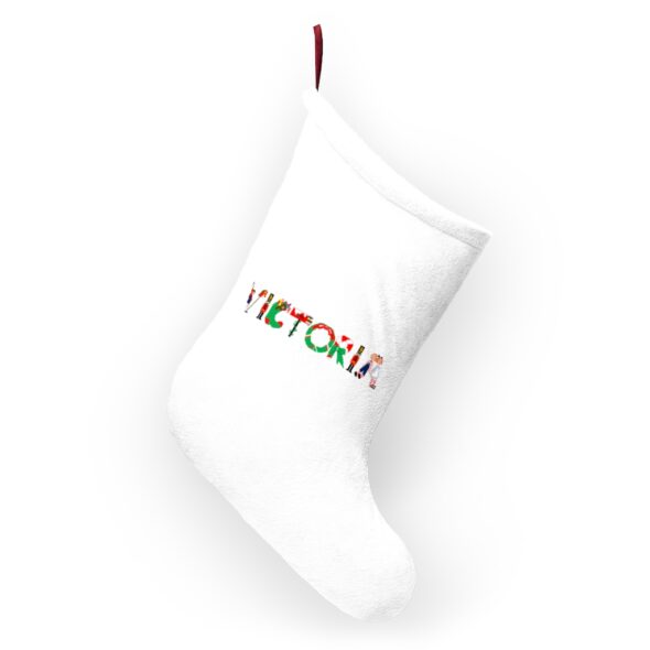 White stocking with text ‘Victoria’ in colourful Christmas themed lettering, with red hanging loop