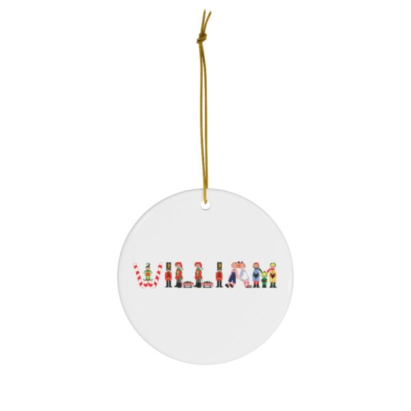 White ceramic ornament with text ‘William’ in colourful Christmas themed lettering, with gold hanging loop