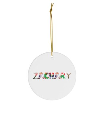 White ceramic ornament with text ‘Zachary’ in colourful Christmas themed lettering, with gold hanging loop