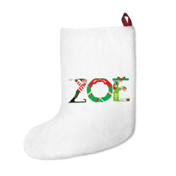 White stocking with text ‘Zoe’ in colourful Christmas themed lettering, with red hanging loop