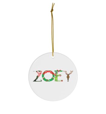 White ceramic ornament with text ‘Zoey’ in colourful Christmas themed lettering, with gold hanging loop