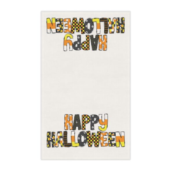 oKitchen towel that features the words 'Happy Halloween' in a seasonally colorful pattern