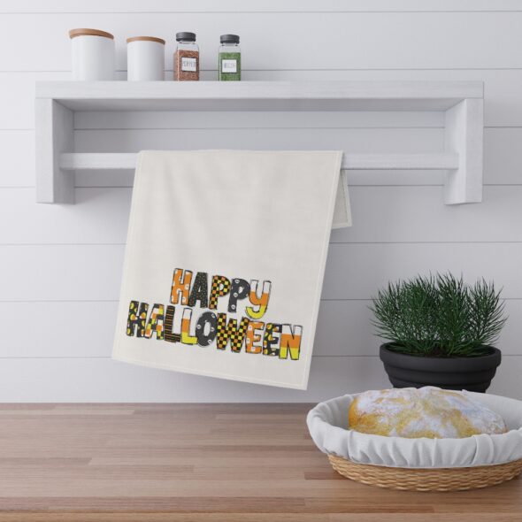 Kitchen towel that features the words 'Happy Halloween' in a seasonally colorful pattern